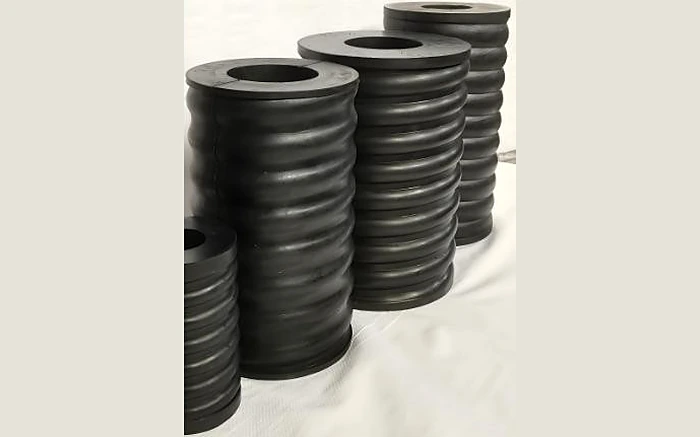 Cylindrical rubber springs with corrugated body and central bore