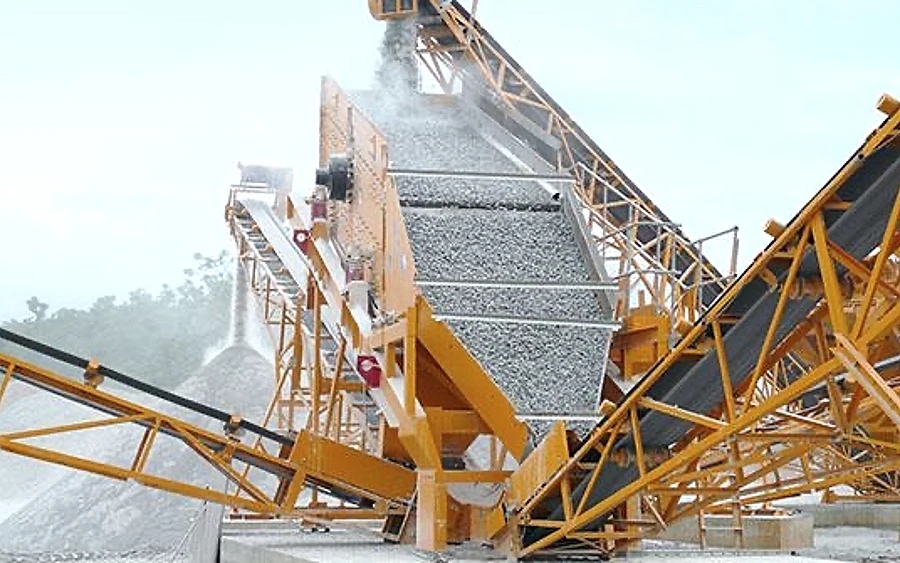 Vibrating screen classifying crushed stone at an aggregates plant — QS line