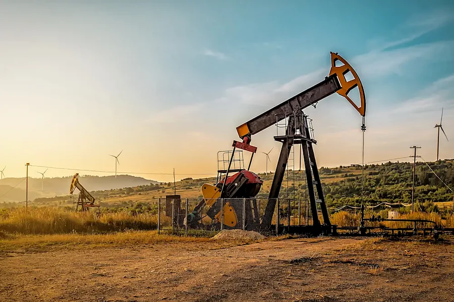 Sucker rod pump in an oil field at dusk